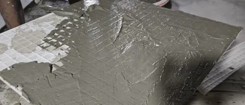 Applying Wet Cement Mortar Layer on Back of Ceramic Tile Stock Footage 341716820
