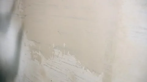 Applying Wet Compound To Wall Surface Carefully, Trowel Spreading Plaster On Stock Footage 323793982