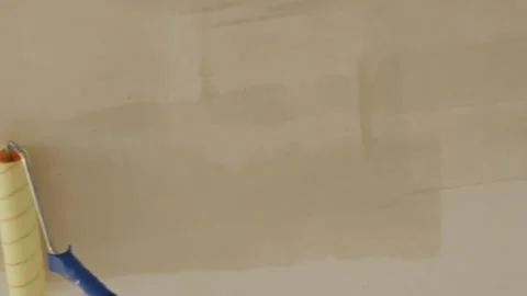 Applying wet liquid primer on concrete ceiling with paint roller Stock Footage 340403935