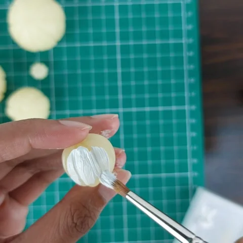 Applying white acrylic paint to a miniature pumpkin craft. Stock Footage 346279270