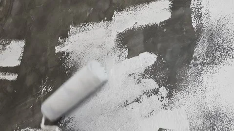 Applying White Primer on Concrete Wall with Paint Roller Stock Footage 342922148