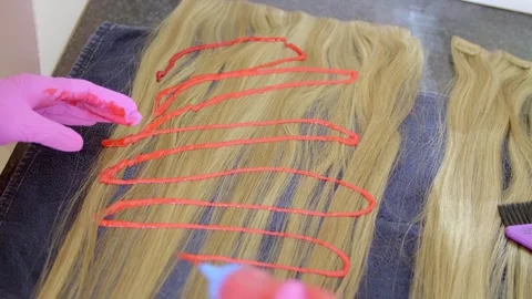 Applying wig dye to a wig Stock Footage 307326524