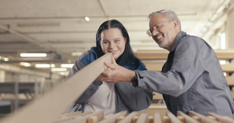 Apprentice and instructor examine wood panel in workshop Stock Footage 254678765