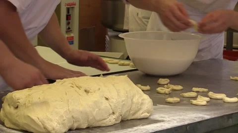 Apprentice Bakers forming rings from dough of pastry mixture for goodies bakery Video stock 51367657