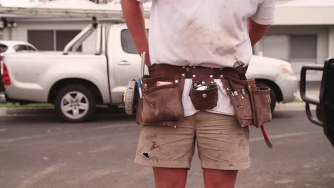 Apprentice builder puts on tool belt ready for work Stock Footage 81994270