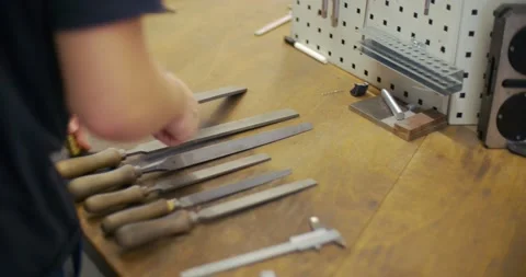 Apprentice choosing and working with metal rasp 스톡 동영상 148763959
