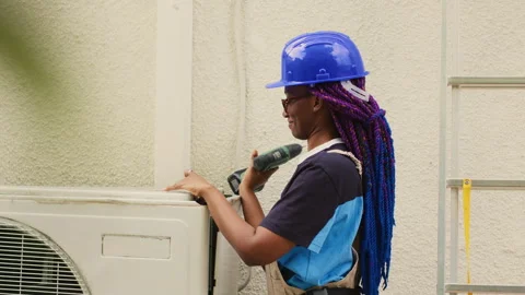 Apprentice dissasembling air conditioner Stock Footage 245525466
