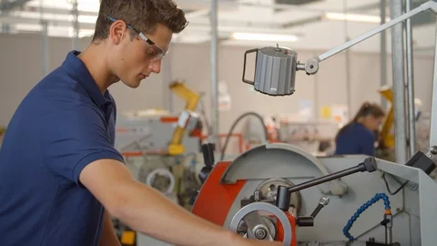 Apprentice Engineer Using Machinery In Manufacturing Plant Stock Footage 86600870