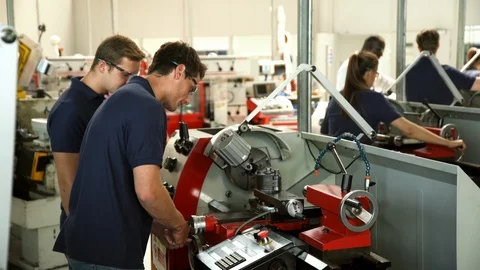 Apprentice Engineers Using Machinery In Manufacturing Plant Stock-Footage 86600952