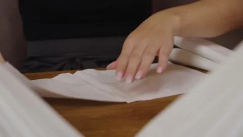 Apprentice folding white napkins in restaurant 스톡 동영상 263509885
