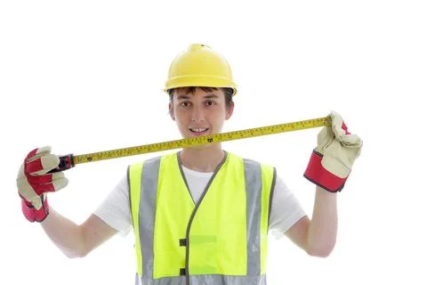 Apprentice holding builders tape measure Young apprentice holding a builde... Stock Photos