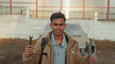 Apprentice mechanic demonstrating repair skills in gritty urban surroundings Video stock 334949580