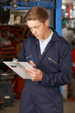 Apprentice Mechanic Working In Auto Repair Shop Stock Photos