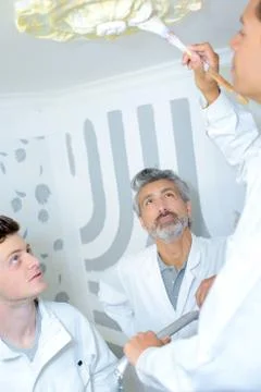 Apprentice painting ceiling rose Stock Photos