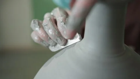Apprentice shapes clay delicately. Quiet studio captures pottery creation Stock Footage 337363637