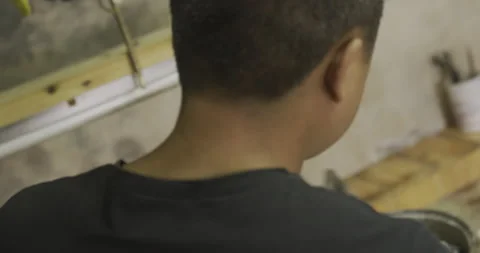 Apprentice uses blow torch above the shoulder shot Stockbeeldmateriaal 141368319