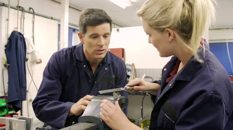 Apprentice Using Metal File On Factory Floor Video stock 40430345