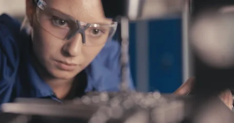 Apprentice watching drill drilling metal in workshop Video stock 254676518