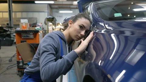 Apprentice working on car body shell in workshop Stock Footage 123162552