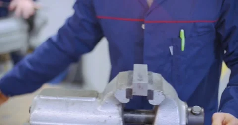 Apprentice working with metal rasp and measuring Stock Footage 148764264