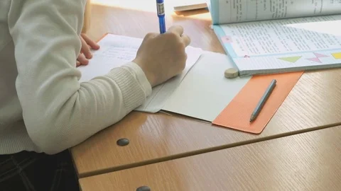 The apprentice writing the text in a copybook Stock Footage 69836923