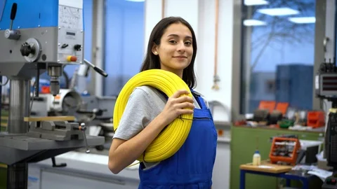 Apprentice with yellow cables in factory 스톡 동영상 129375056