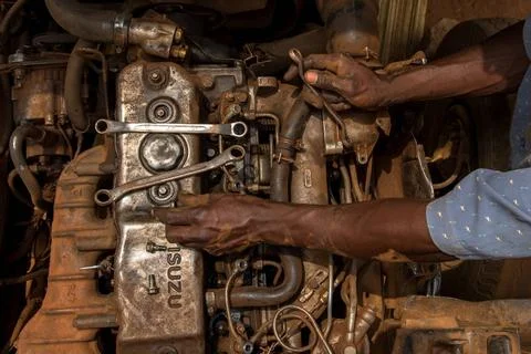  Apprentices learning how to repair an engine, Masindi, Uganda. Apprentice... Stock Photos