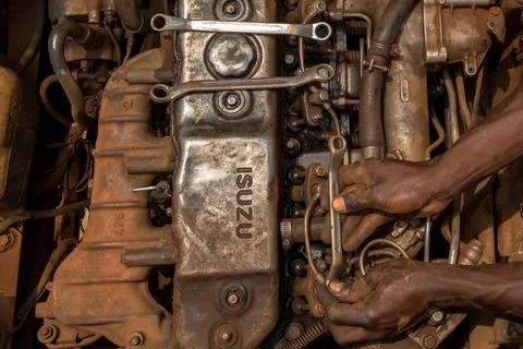  Apprentices learning how to repair an engine, Masindi, Uganda. Apprentice... Stock Photos