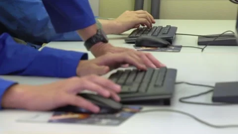 Apprentices working on computer keyboard and mouse in classroom Video stock 237316210