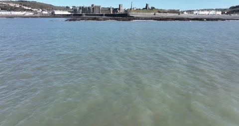 Approach to Aberystwyth Seafront from over the Ocean Stock Footage 264831173