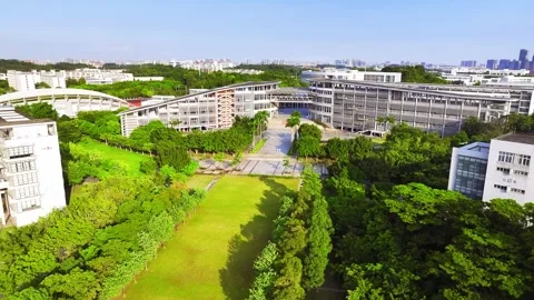Approach above a tree lined university lawn in Guangzhou China Stock Footage 345959680