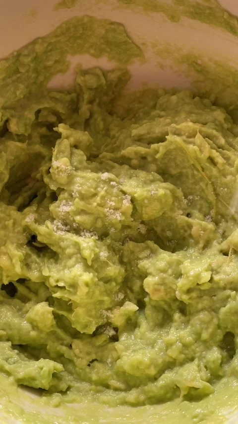 Approach of salt falling on guacamole Stock Footage 288255874
