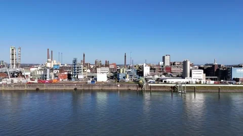 Approach toward industrial complex across river aerial Stock Footage 331201148