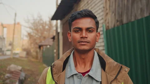 Approachable handyman with reflective gear during sunset break. Street repair Stock Footage 345155213