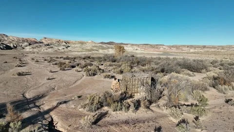 Approaching an abandoned cabin on a cattle ranch in the middle of the desert Stock Footage 165566505