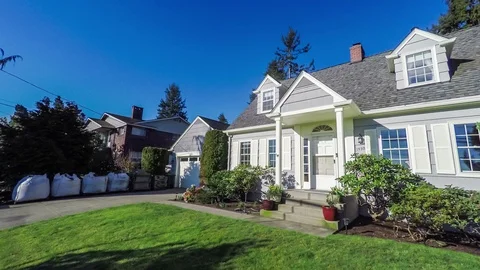 Approaching an American suburban Cape Cod style home; dolly shot Stock Footage 94497758
