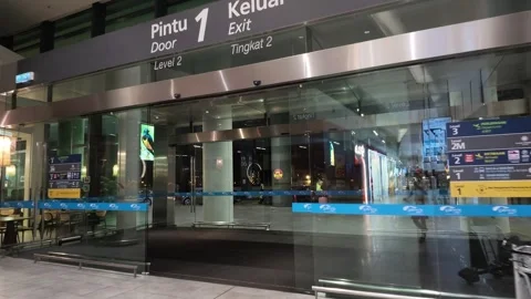 Approaching automatic glass exit door Door 1 at KLIA Terminal 2, Malaysia. Stock Footage 340939489