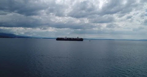 Approaching close to container carrying ship on a nice cloudy day Stockbeeldmateriaal 75475839