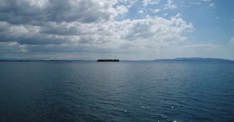 Approaching container ship on a sunny cloudy day oversea flight Stockbeeldmateriaal 75475986
