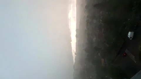 Approaching dark storm clouds and rain during heavy downpour over city buildings Stock Footage 313614303