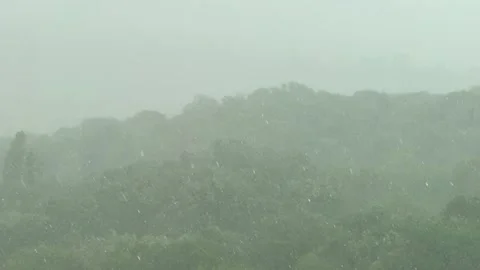 Approaching dark storm clouds and rain during heavy downpour over city buildings Vídeo Stock 313621364