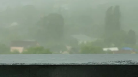 Approaching dark storm clouds and rain during heavy downpour over city buildings Stock Footage 313621462