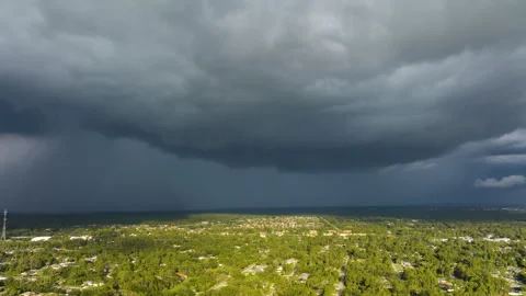 Approaching dark stormy clouds forming on gloomy sky during heavy rainfall over Stock Footage 242755059
