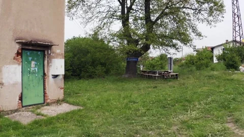 Approaching drone shot of an old building, a tree landmark, benches, Stock Footage 265991513