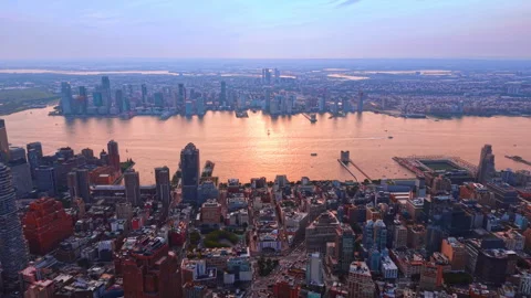 Approaching the East River colored orange by the setting sun. Vast panorama of Stock Footage 347677367