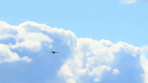 Approaching F-18 fighter jet flying beneath the clouds, showcasing mil Stock Footage 317733218