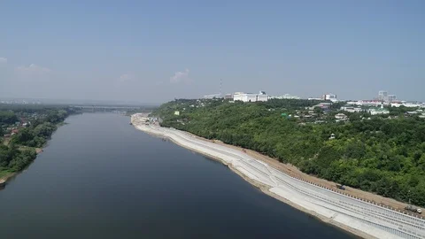 Approaching frame of the river and edge of promenade with a forest on the edge. Stock Footage 127794923