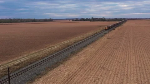 An Approaching Freight Train Crossing Plowed Fields, Brazos County, Texas, USA Stock Footage 145947824