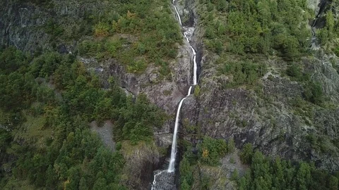 Approaching Graceful Leaps and Pools of a Waterfall on Forest Cliffs Stock Footage 81492064