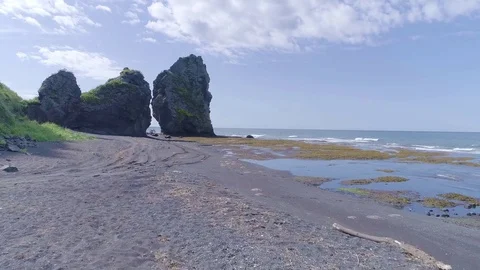 Approaching Large rocks on the shoreline Stock Footage 80079324